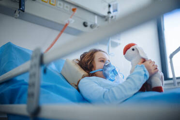 Close-up of girl with infection disease lying in hospital room. - HPIF10234