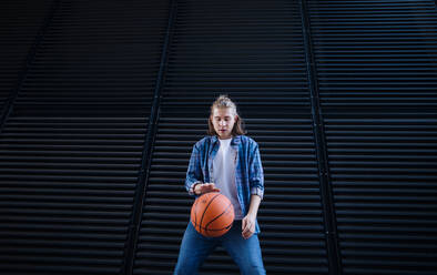 Young man dribbling with a basketball ball,outdoor in city. Youth culture. - HPIF10623