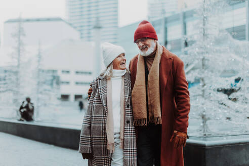 Senior couple walking in a winter city center. - HPIF11164