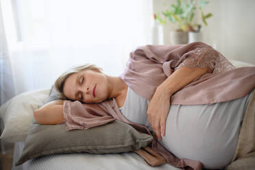 Pregnant woman sleeping and resting in a bed. - HPIF11617