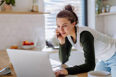 Young woman having homeoffice in a kitchen. - HPIF12050