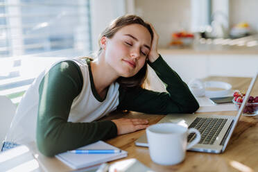 Young woman fall asleep at the table during learning. - HPIF12082