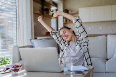 Young woman stretching during homeoffice in an apartment. - HPIF12097
