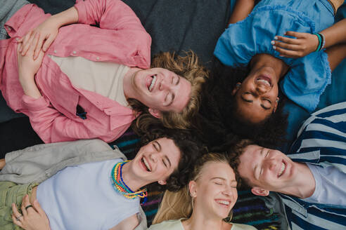 A top view of diverse group of friends having fun together at park lauging and lying on ground, Friendship and lifestyle concepts - HPIF12237