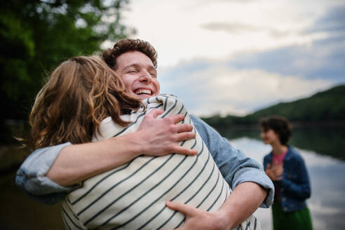 Friends having fun together at a park lauging and hugging, Friendship and lifestyle concepts - HPIF12276