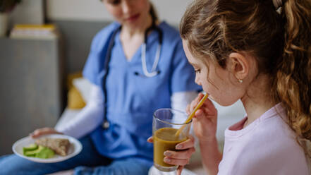 Close up of little girl having healthy breakfast in a hospital room. - HPIF12675