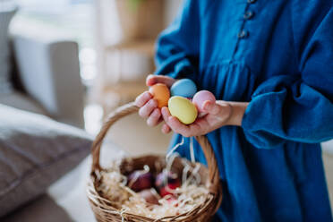 Close-up of little girl holding basket with the easter eggs. - HPIF12771
