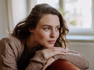 Portrait of young pensive woman, in the apartment. - HPIF12882