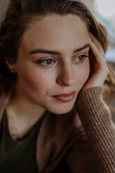 Portrait of young pensive woman, in the apartment. - HPIF12922