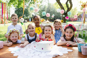 Kids birthday party outdoors in garden in summer, a celebration concept. - HPIF13210