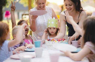 Kids birthday party outdoors in garden in summer, a celebration concept. - HPIF13224