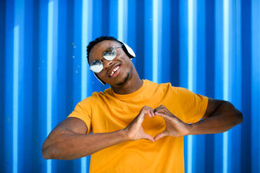 Porträt eines fröhlichen jungen schwarzen Mannes vor blauem Hintergrund, Black Lives Materie Konzept. - HPIF13266