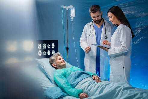 An infected patient in quarantine lying in bed in hospital, coronavirus concept. - HPIF13747