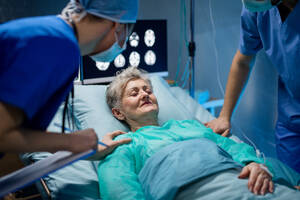 An infected patient in quarantine lying in bed in hospital, coronavirus concept. - HPIF13749