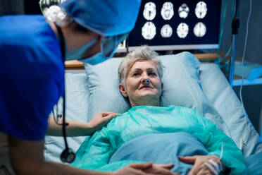 An infected patient in quarantine lying in bed in hospital, coronavirus concept. - HPIF13751