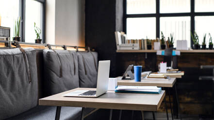 Laptops on desks in empty modern office, business concept. - HPIF13910