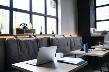 Laptops on desks in empty modern office, business concept. - HPIF13911