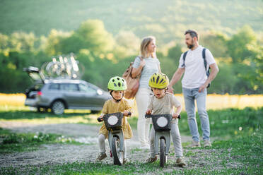 Family with two small children going on cycling trip by car in countryside. - HPIF13969