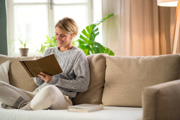 Portrait of woman relaxing indoors at home, mental health care concept. Copy space. - HPIF14025