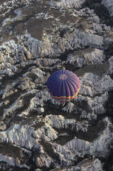 Aerial view of a hot air balloon above the fairy chimneys, Cappadocia, Turkey. - AAEF17853