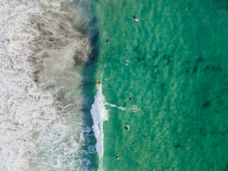 Luftaufnahme von Menschen beim Surfen im Meer in Camps Bay, Kapstadt, Südafrika. - AAEF18008