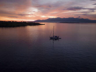 Aerial view of sailing vessels during golden hour anchoring near Tobelo, Halmahera, Indonesia. - AAEF18044