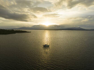 Aerial view of sailing vessels during golden hour anchoring near Tobelo, Halmahera, Indonesia. - AAEF18047