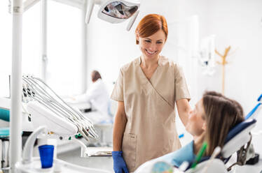 A females dentist talking to woman in dental surgery, annual check-up. - HPIF14193