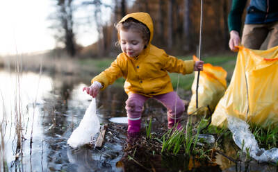 Unrecognizable father with small daughter working outdoors in garden, sustainable lifestyle concept. - HPIF14413