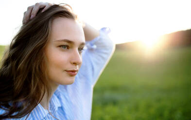 Close-up portrait of young teenager girl outdoors in nature at sunset - HPIF14616