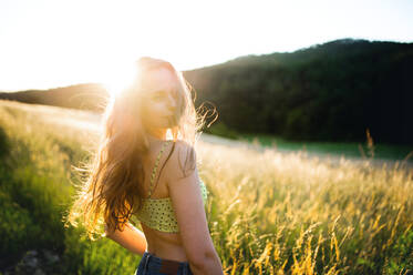 Portrait of young teenager girl outdoors in nature at sunset. Copy space. - HPIF14855