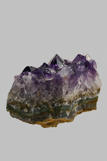 Close up textured purple Uruguayan amethyst crystal on gray background - FSIF06310