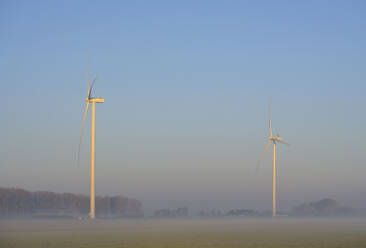 Netherlands, Noord-Brabant, Wind turbines on misty morning - ISF26052