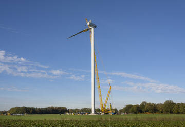 Wind turbine under construction in field - ISF26055