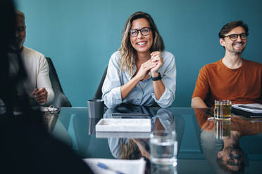 Group of business professionals working together on a project in an office boardroom. Diverse team of colleagues collaborating and innovating for a successful corporate project. - JLPPF01965