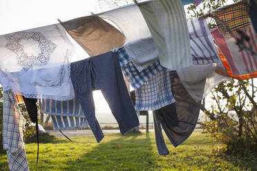 Windblown clothes on clothesline at sunset - FOLF12142