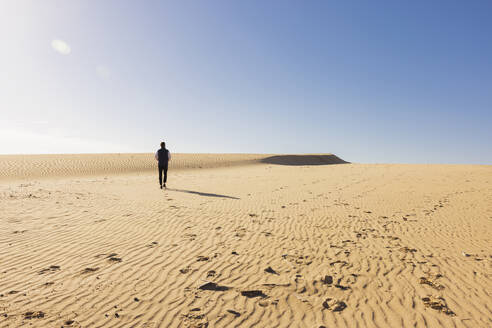 Mid adult man jogging on sand dunes - FOLF12183