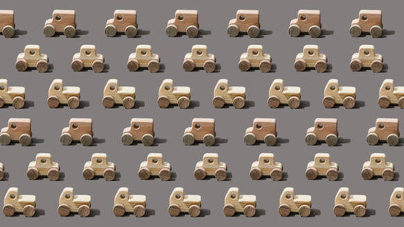 Wooden cars arranged on gray background - FLMF00975