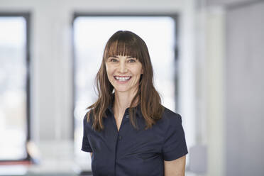 Portrait of smiling businesswoman in office - RORF03578