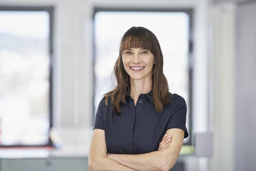 Portrait of smiling businesswoman in office - RORF03580