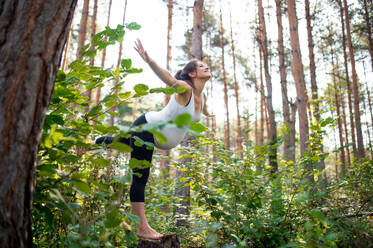 Side view portrait of happy pregnant woman outdoors in nature, doing exercise. - HPIF15825