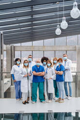 A group of doctors with face masks looking at camera, corona virus concept. - HPIF16080