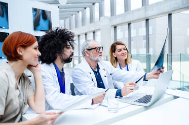 A group of doctors looking at X-ray on medical conference, discussing issues. - HPIF16087