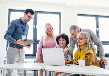 Group of cheerful senior people attending computer and technology education class. - HPIF16391