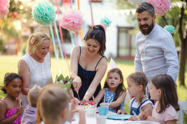 Happy kids birthday party outdoors in garden in summer, celebration concept. - HPIF17661