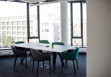 A large table with chairs in boardroom, an interior of office building. - HPIF18355