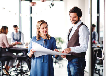 A group of young business people in an office, discussing issues when working. - HPIF18426