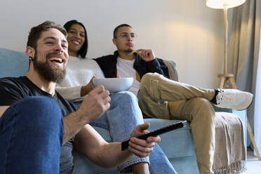 Cheerful friends spending leisure time watching TV at home - SOBF00008