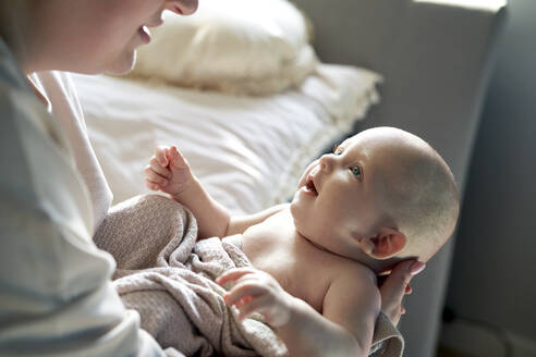 Mother holding cute baby girl at home - ABIF01980