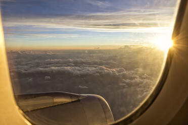 Cloudscape from aircraft window at sunset - MAMF02862